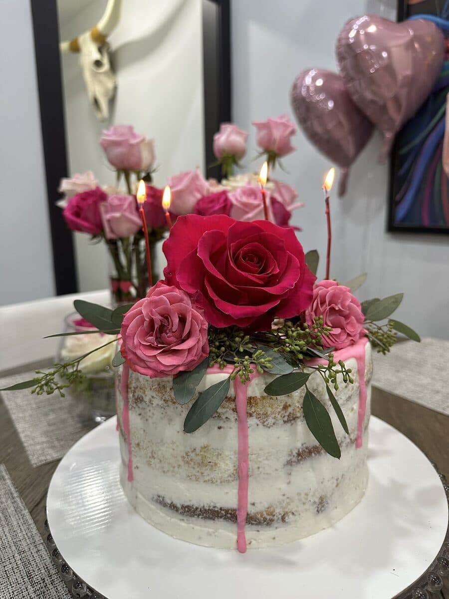 Semi-naked cake decorated with fresh pink roses