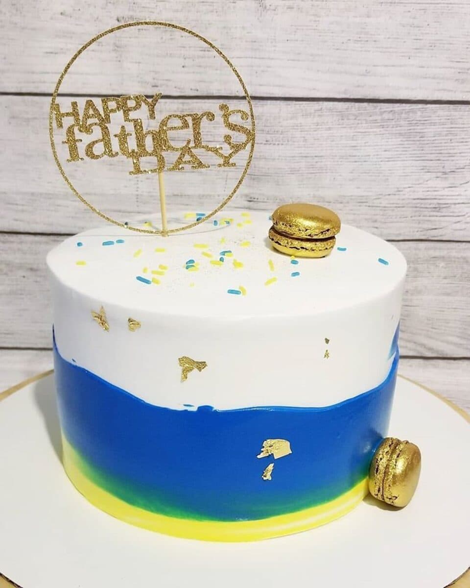 Father's Day beach-themed cake in blue and white