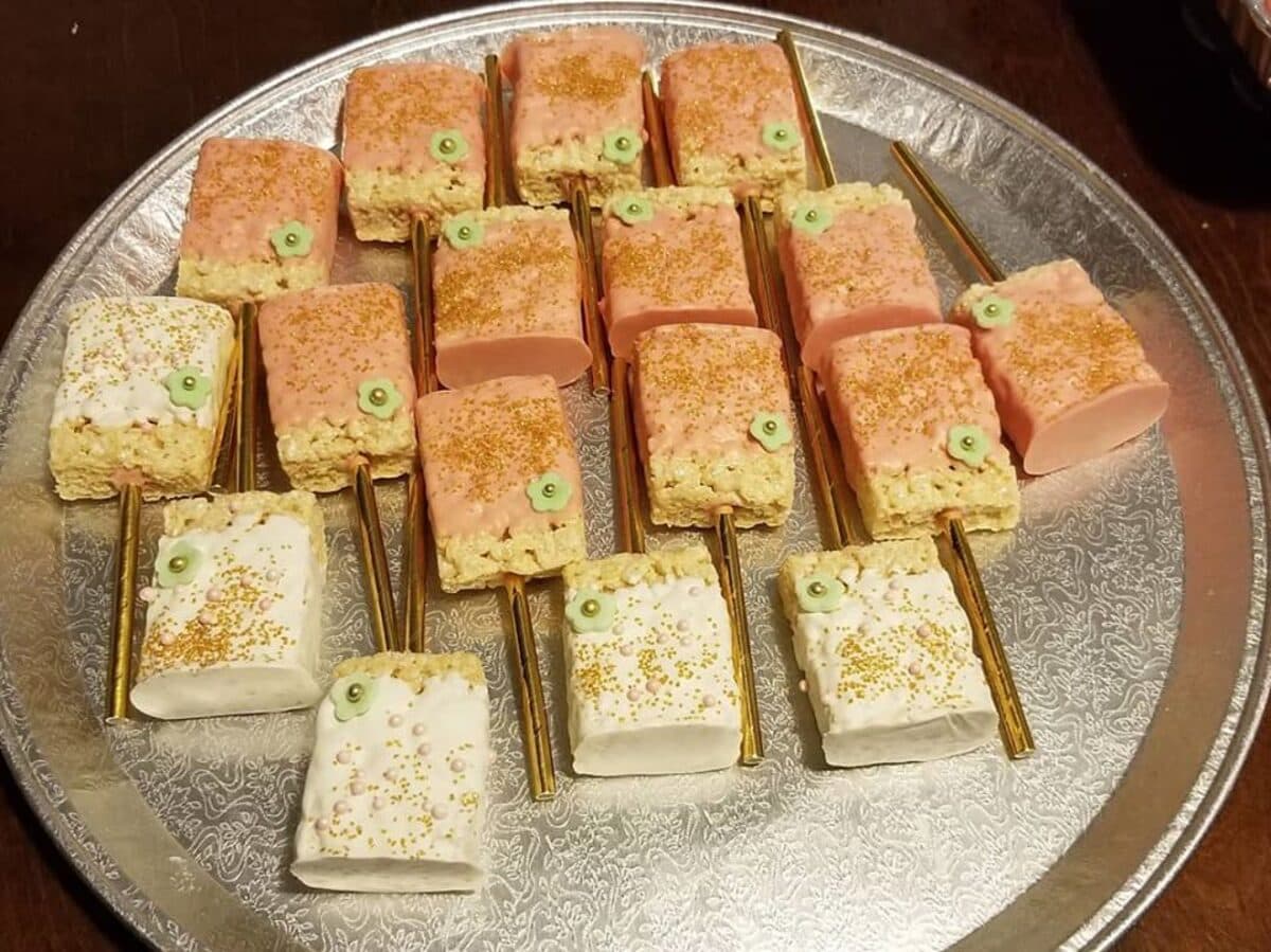 Tray of frosted dessert bars with gold sprinkles