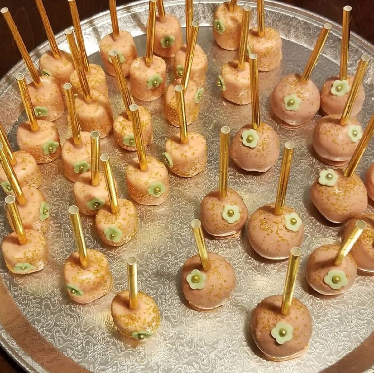 Chocolate-covered candy apples with gold sticks