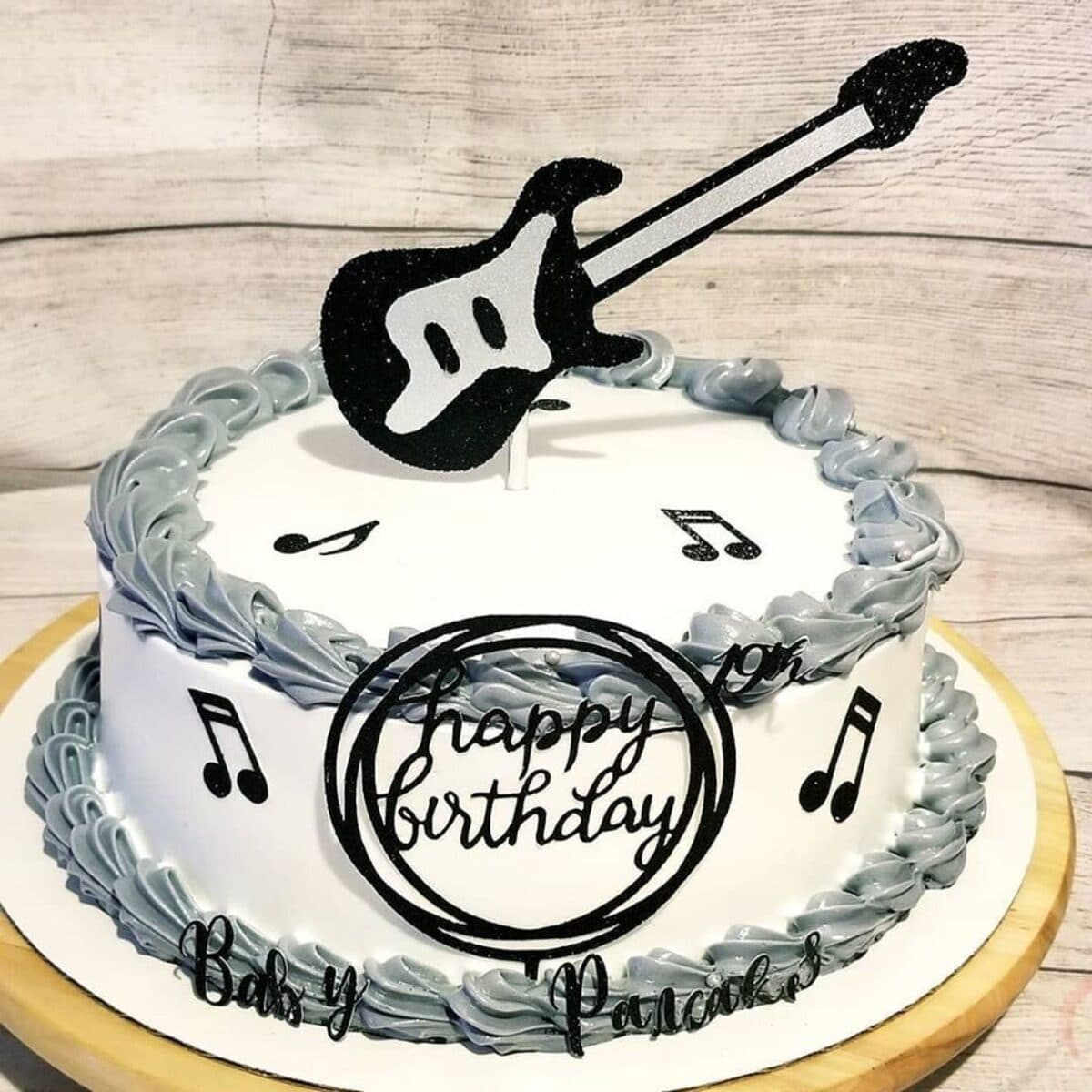 Music-themed birthday cake with guitar topper